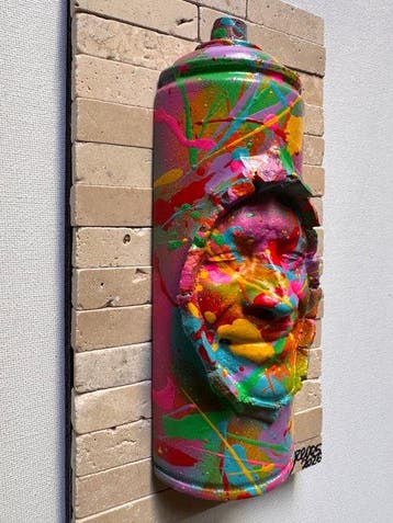 gregos - Colored smiling spray can on bricks