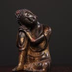 A brass statue of the Contemplating Buddha from a private