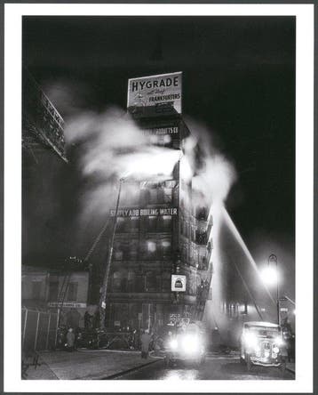 Weegee (1899–1968) - Putting Out The Fire, New York 1937
