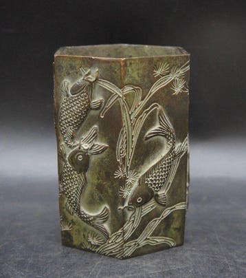 Cast bronze hexagonal pen with nine carp carvings, head -