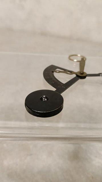 Vintage pocket postal scales (pendulum-style letter scales).