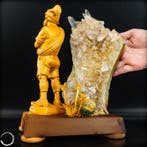 natuurlijke naaldkwartslaag met gesneden houten figuur – Een