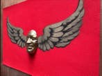 gregos - Flying smile-black and gold on red background