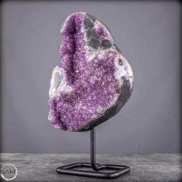 Gloeiende amethist op metalen standaard – elegantie in