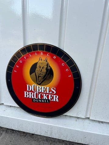 Dübels Brücker Dunkel – Rond Bier Reclamebord – Teuflisch