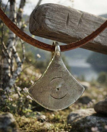 Viking periode Zilver Bijlvormige amulet met zonnesymbolen.