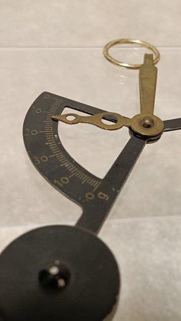 Vintage pocket postal scales (pendulum-style letter scales).
