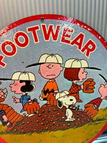Peanuts ‘Footwear’ enamel advertising sign featuring Snoopy