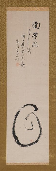 Hangende rol met een Daruma die naar de muur gericht is. -