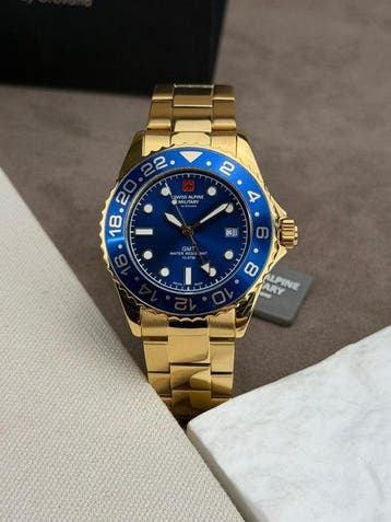 Swiss Alpine Military - GMT diver Date Gold/Blue - Sans prix, Handtassen en Accessoires, Nieuw