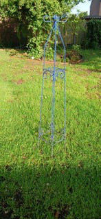 Large blue metal garden obelisk used for climbing plants -