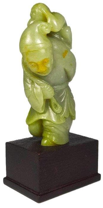 A Chinese Celadon Jade Carving of a Monkey and Man Group,