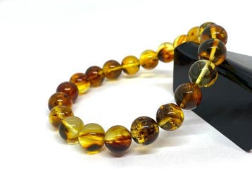 Bosmos-inclusies - Baltische barnsteen ronde kralen armband