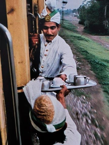 Steve McCurry (1950–) - Breakfast tea passed between train