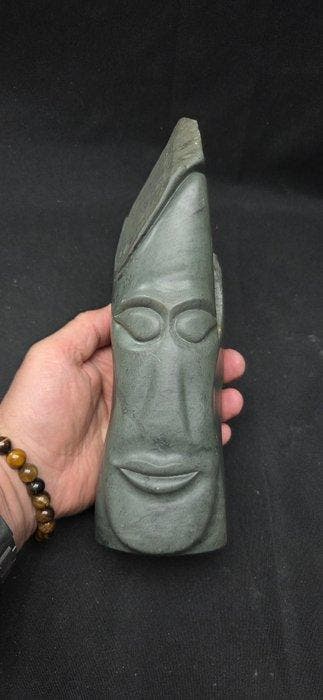 Large serpentine head sculpture in the Pacific style, signed