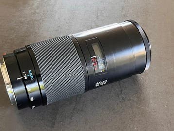 Minolta AF f4/70-210mm + 1 lensdop en zonnekap. Zoomlens, Nieuw