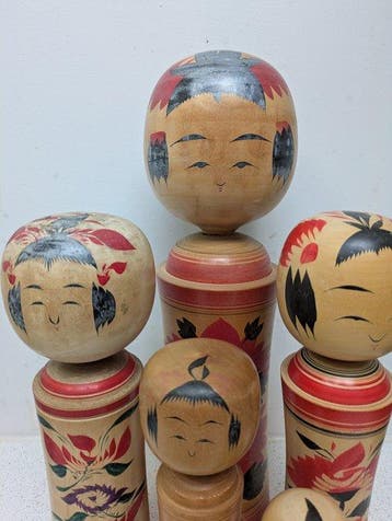 Een set vintage kokeshi-poppen in de klassieke Naruko-stijl