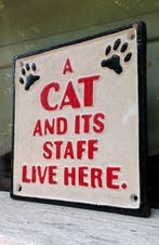 « Un chat et son personnel vivent ici » – panneau